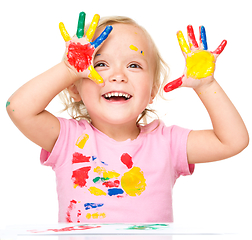 Image showing Portrait of a cute little girl playing with paints