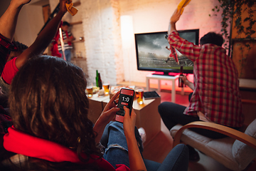 Image showing Group of friends watching TV, sport match together. Emotional man cheering for favourite team, celebrating successful betting. Concept of friendship, leisure activity, emotions