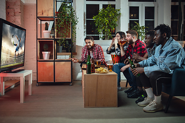 Image showing Group of friends watching TV, sport match together. Emotional fans cheering for favourite team, watching on exciting game. Concept of friendship, leisure activity, emotions