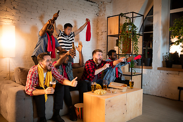 Image showing Group of friends watching TV, sport match together. Emotional fans cheering for favourite team, watching on exciting game. Concept of friendship, leisure activity, emotions