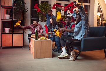 Image showing Group of friends watching TV, sport match together. Emotional fans cheering for favourite team, watching on exciting game. Concept of friendship, leisure activity, emotions