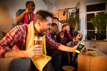 Image showing Group of friends watching TV, sport match together. Emotional man cheering for favourite team, celebrating successful betting. Concept of friendship, leisure activity, emotions