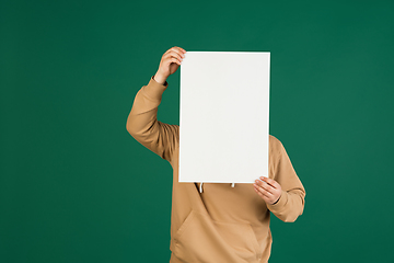 Image showing Asian man\'s portrait isolated over green studio background with copyspace