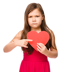 Image showing Portrait of a sad little girl in red