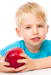 Image showing Portrait of a cute little boy with red apple