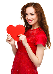 Image showing Young woman holding red heart