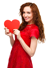 Image showing Young woman holding red heart