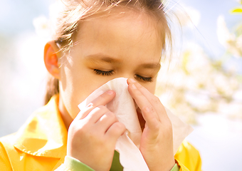 Image showing Little girl is blowing her nose