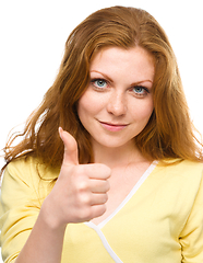 Image showing Woman is showing thumb up gesture