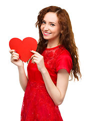 Image showing Young woman holding red heart