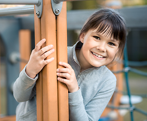 Image showing Cute little girl is playing in playground