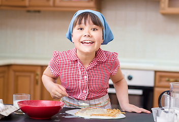 Image showing Girl is cooking in kitchen