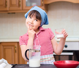 Image showing Girl is cooking in kitchen