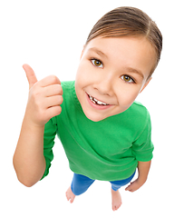 Image showing Little girl is showing thumb up gesture