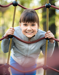 Image showing Cute little girl is playing in playground