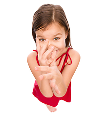 Image showing Little girl in red dress showing big nose