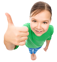 Image showing Little girl is showing thumb up gesture