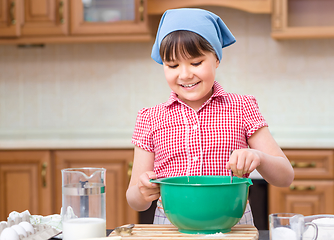 Image showing Girl is cooking in kitchen