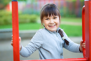 Image showing Cute little girl is playing in playground