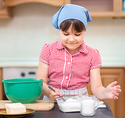 Image showing Girl is cooking in kitchen