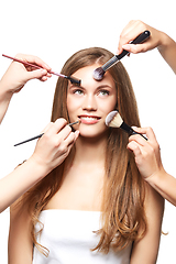 Image showing beautiful girl with makeup brushes