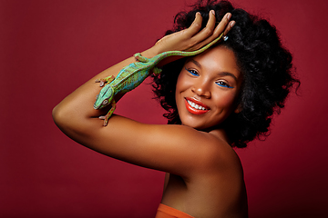 Image showing beautiful woman holding chameleon