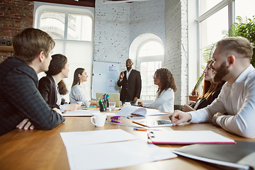 Image showing Group of young business professionals having a meeting, creative office