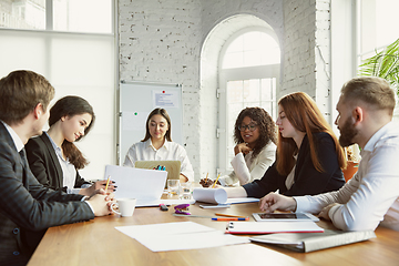 Image showing Group of young business professionals having a meeting, creative office