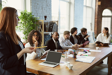 Image showing Group of young business professionals having a meeting, creative office