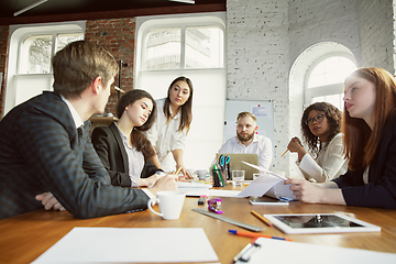 Image showing Group of young business professionals having a meeting, creative office