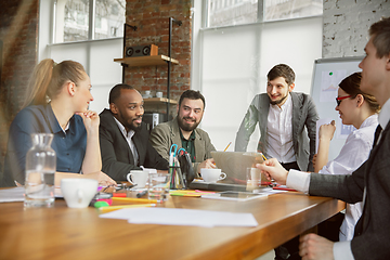 Image showing Group of young business professionals having a meeting, creative office