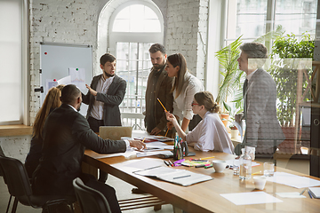 Image showing Group of young business professionals having a meeting, creative office