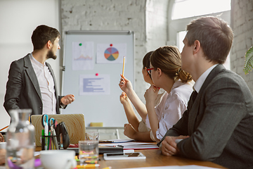 Image showing Group of young business professionals having a meeting, creative office