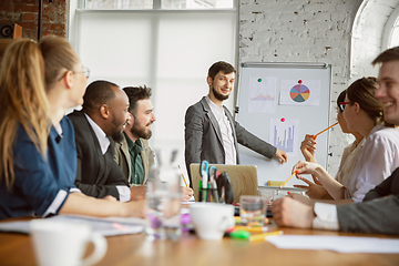 Image showing Group of young business professionals having a meeting, creative office