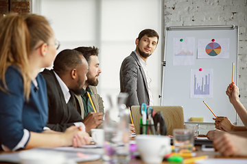 Image showing Group of young business professionals having a meeting, creative office