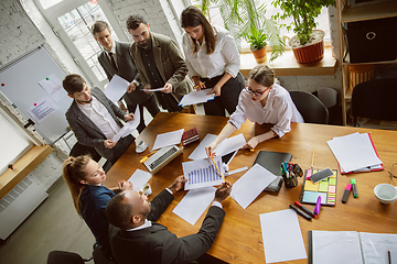 Image showing Group of young business professionals having a meeting, creative office