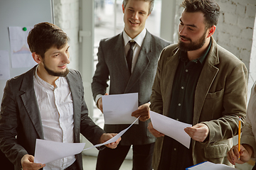 Image showing Group of young business professionals having a meeting, creative office