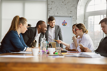 Image showing Group of young business professionals having a meeting, creative office