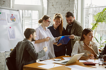 Image showing Group of young business professionals having a meeting, creative office