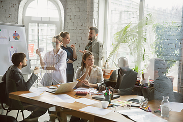 Image showing Group of young business professionals having a meeting, creative office