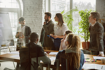 Image showing Group of young business professionals having a meeting, creative office