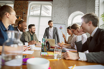 Image showing Group of young business professionals having a meeting, creative office