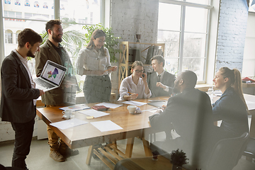 Image showing Group of young business professionals having a meeting, creative office