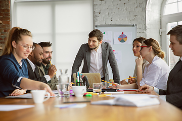 Image showing Group of young business professionals having a meeting, creative office