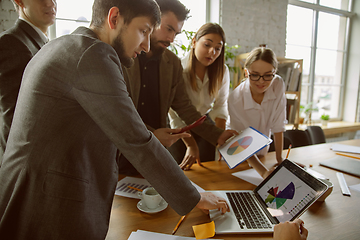 Image showing Group of young business professionals having a meeting, creative office