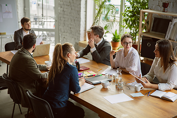 Image showing Group of young business professionals having a meeting, creative office