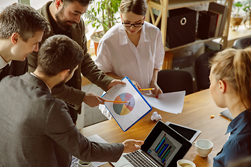 Image showing Group of young business professionals having a meeting, creative office