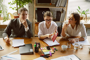 Image showing Group of young business professionals having a meeting, creative office