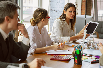 Image showing Group of young business professionals having a meeting, creative office