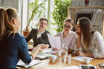 Image showing Group of young business professionals having a meeting, creative office